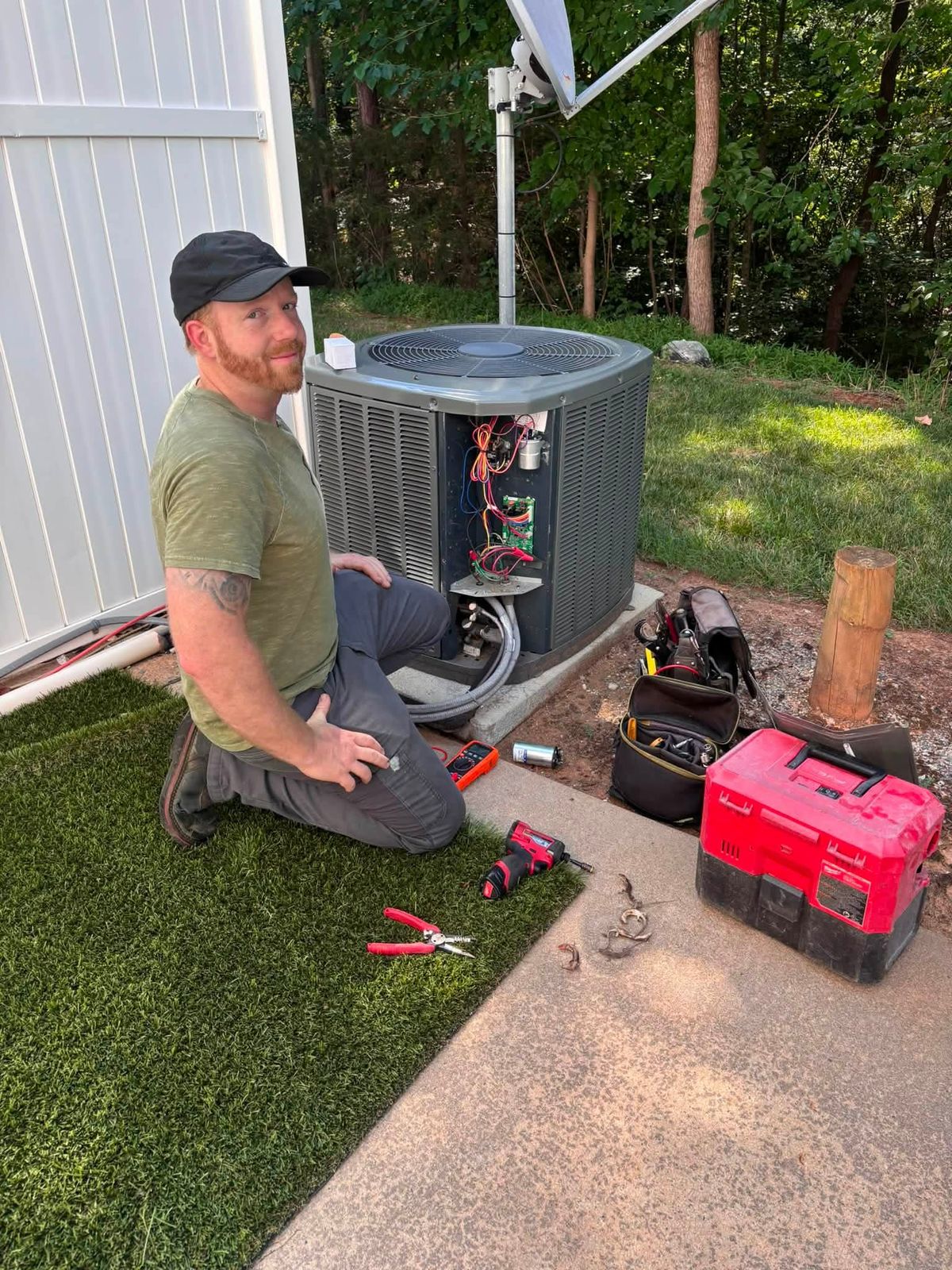 Adam, owner of Integrity Air Solutions, working on a condenser